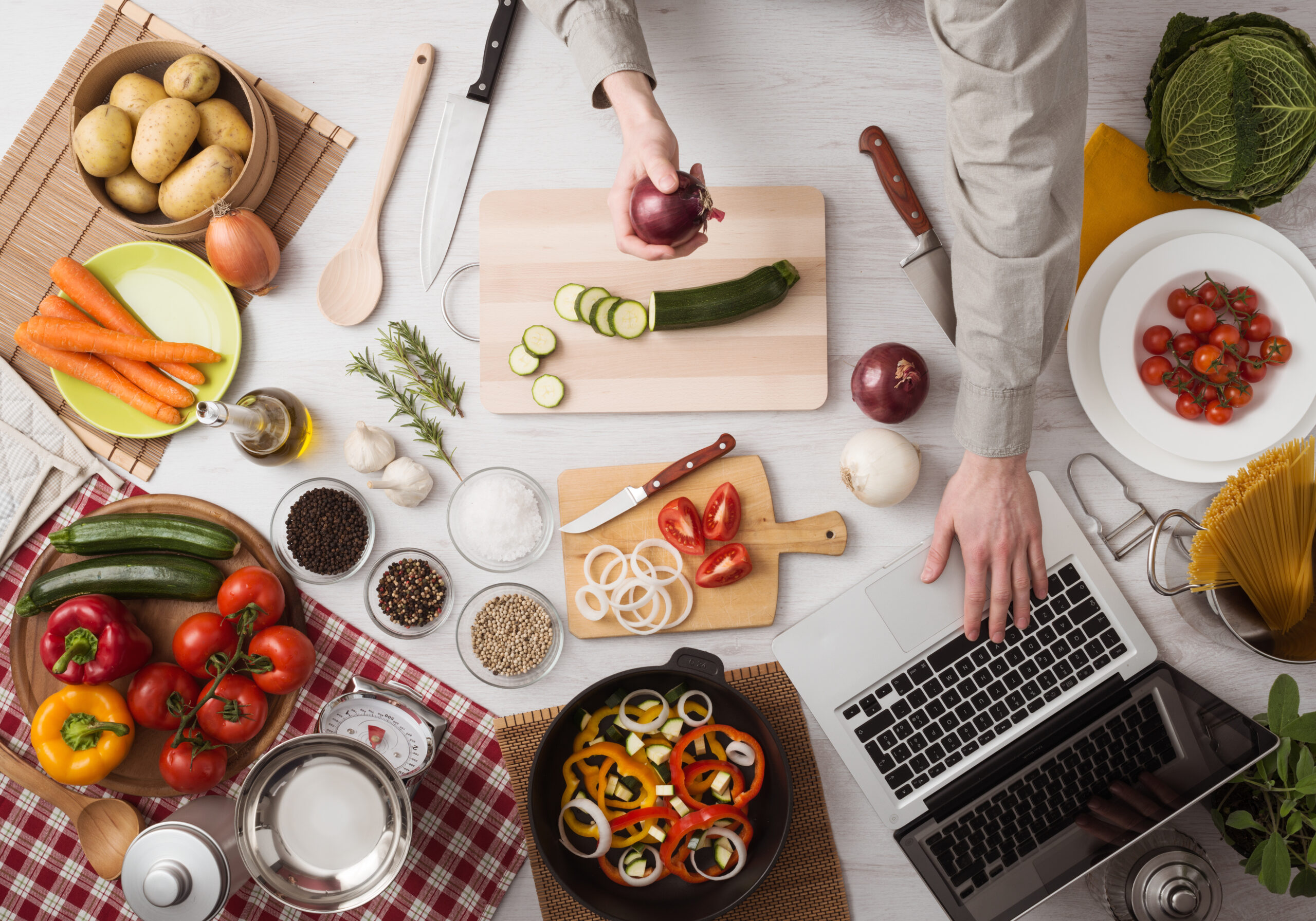 Laptop with tons of ingredients surrounding it